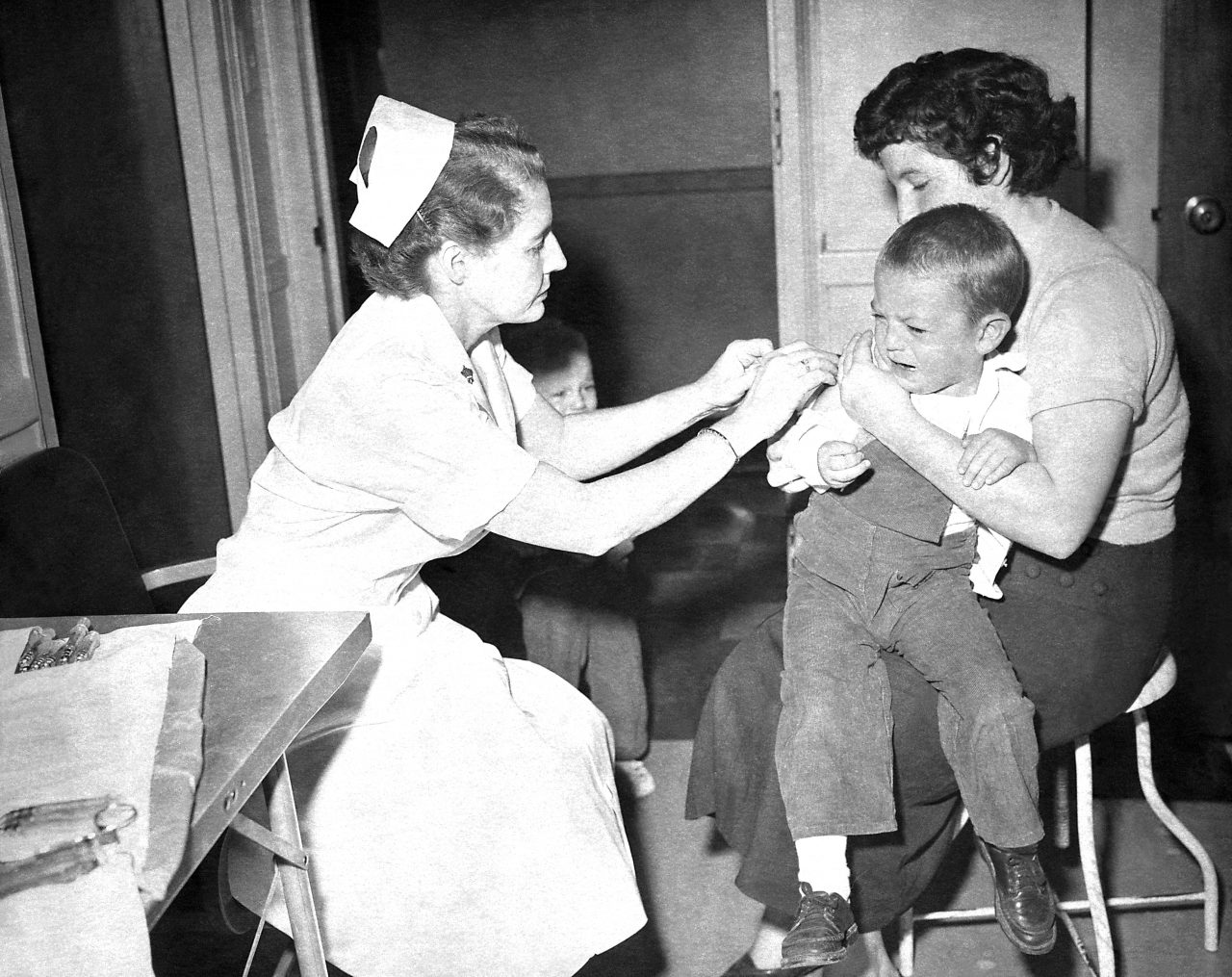 Small child as he received a smallpox vaccination at a local hea