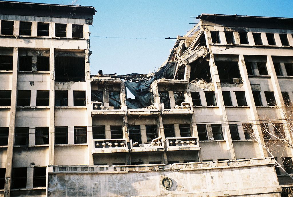 1024px-Bombed_building_on_ulica_knez_milosa.jpg